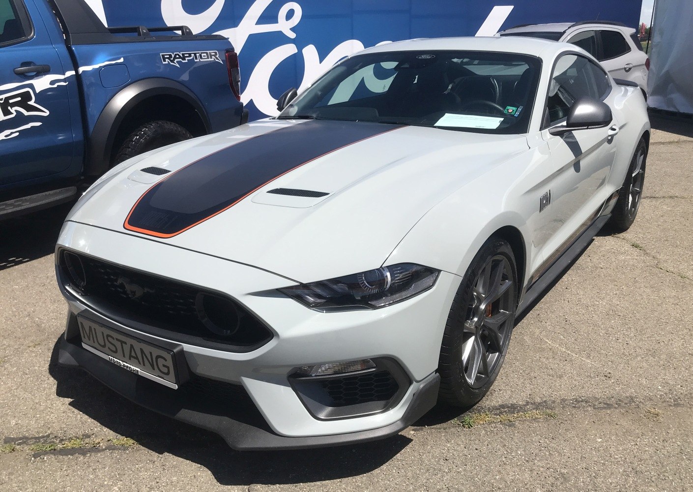 Front side view with hood racing stripe and sporty wheels