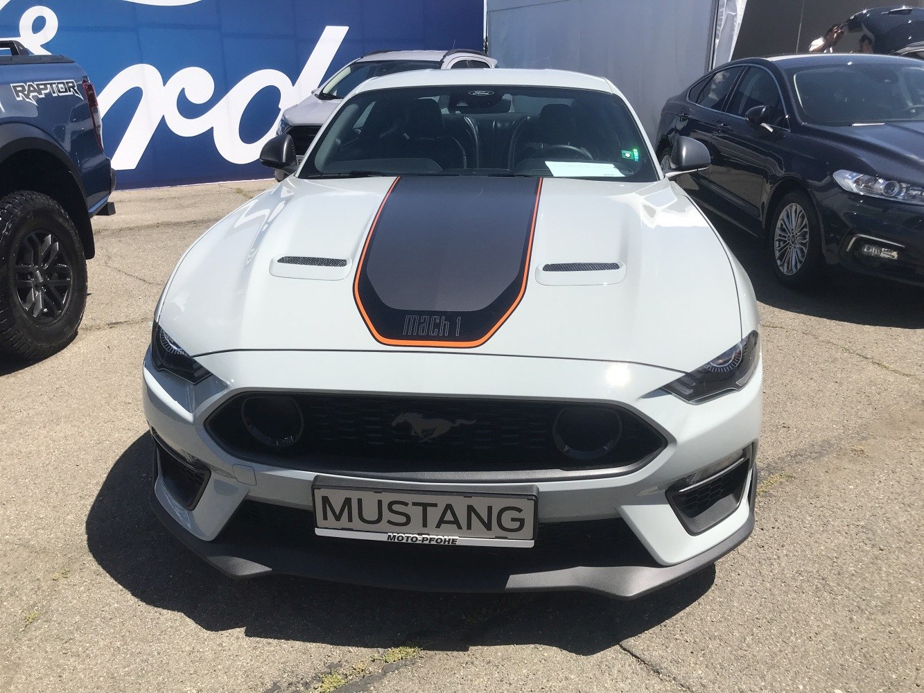 Front view of a Mustang with black hood stripe and aggressive grille