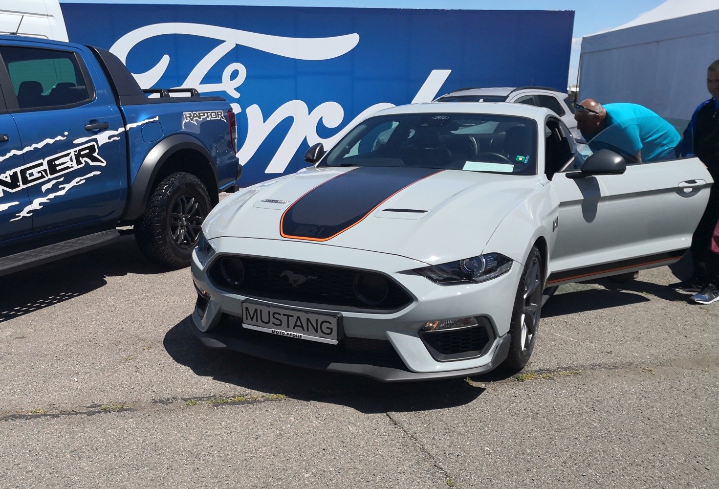 Front view of a muscle car with hood scoop and aggressive grille