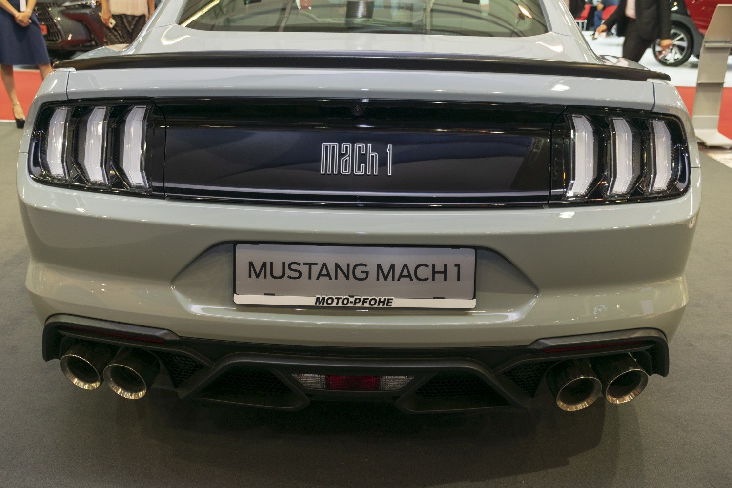 Rear view with quad exhausts, distinct taillights, Mach 1 badge
