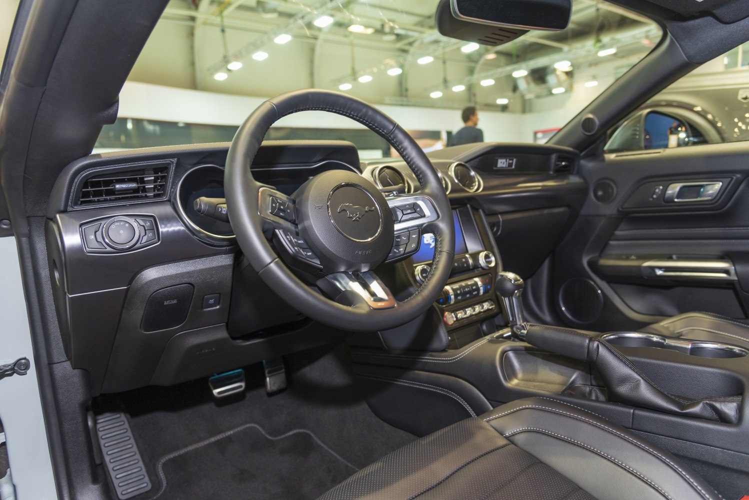 Steering wheel, dashboard, and center console interior details.