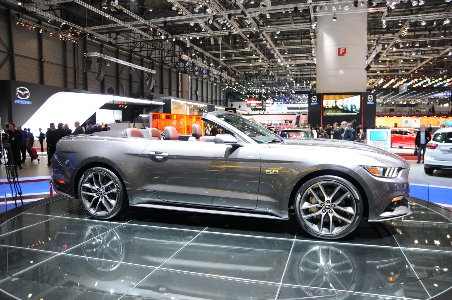 Side profile of a convertible with alloy wheels and open roof