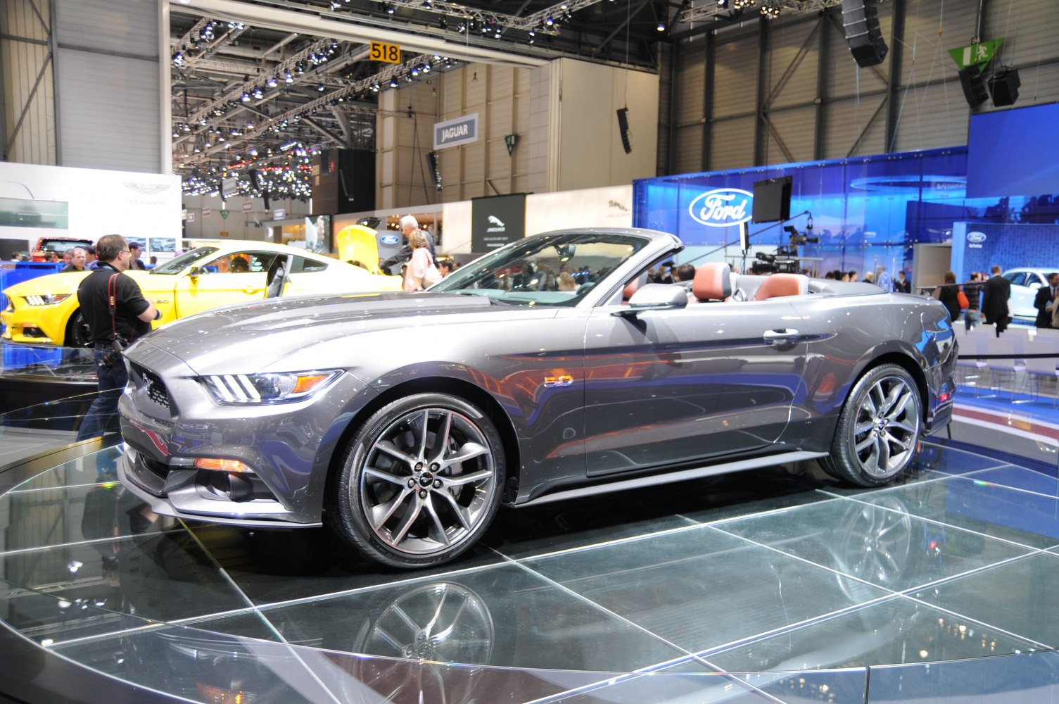 Convertible sports car with alloy wheels and sleek grey body.