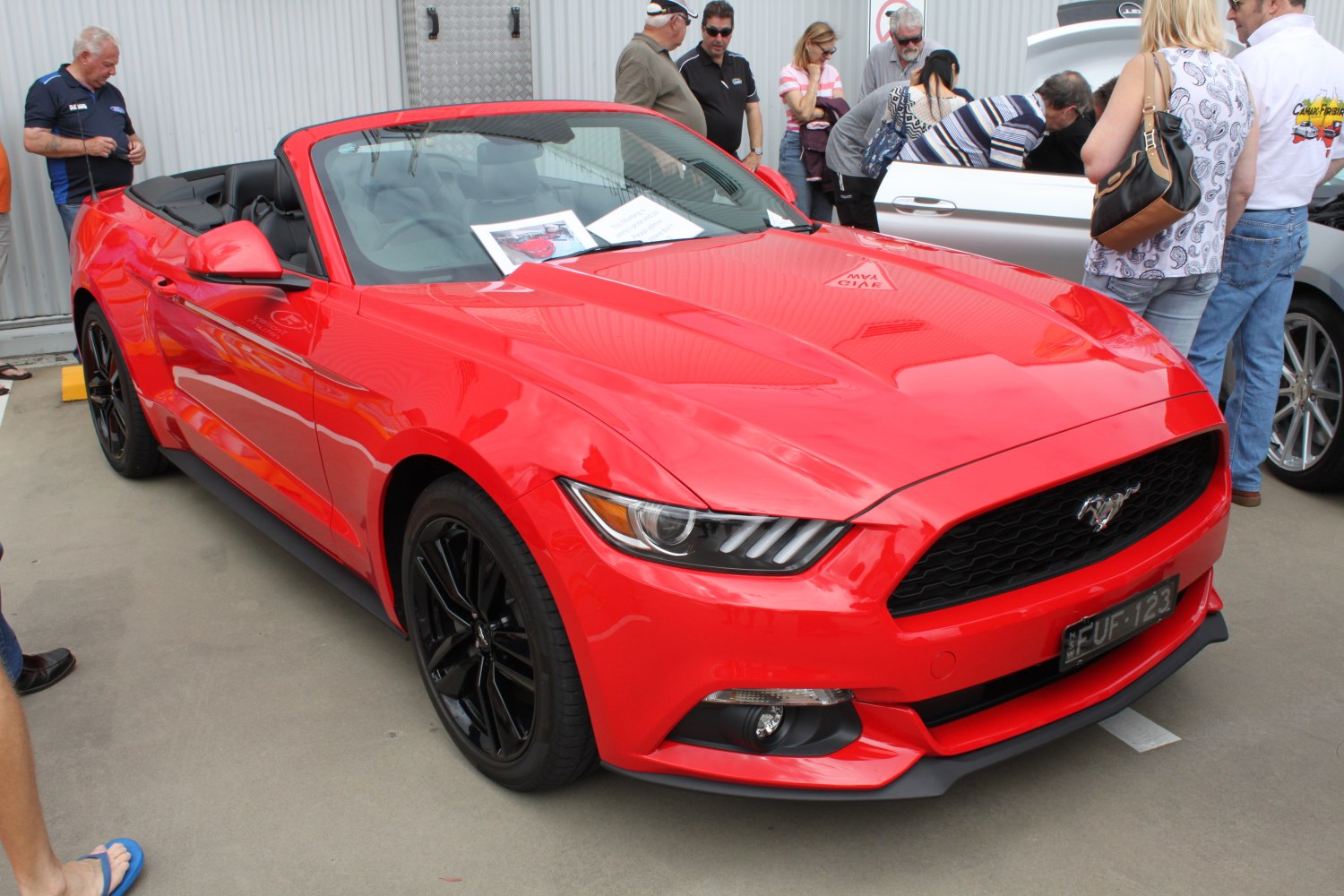 Front view of red convertible with LED headlights and black wheels