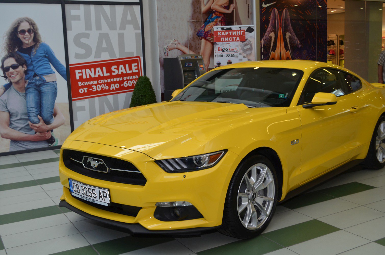 Yellow Mustang VI front-side view with headlights and alloy wheels