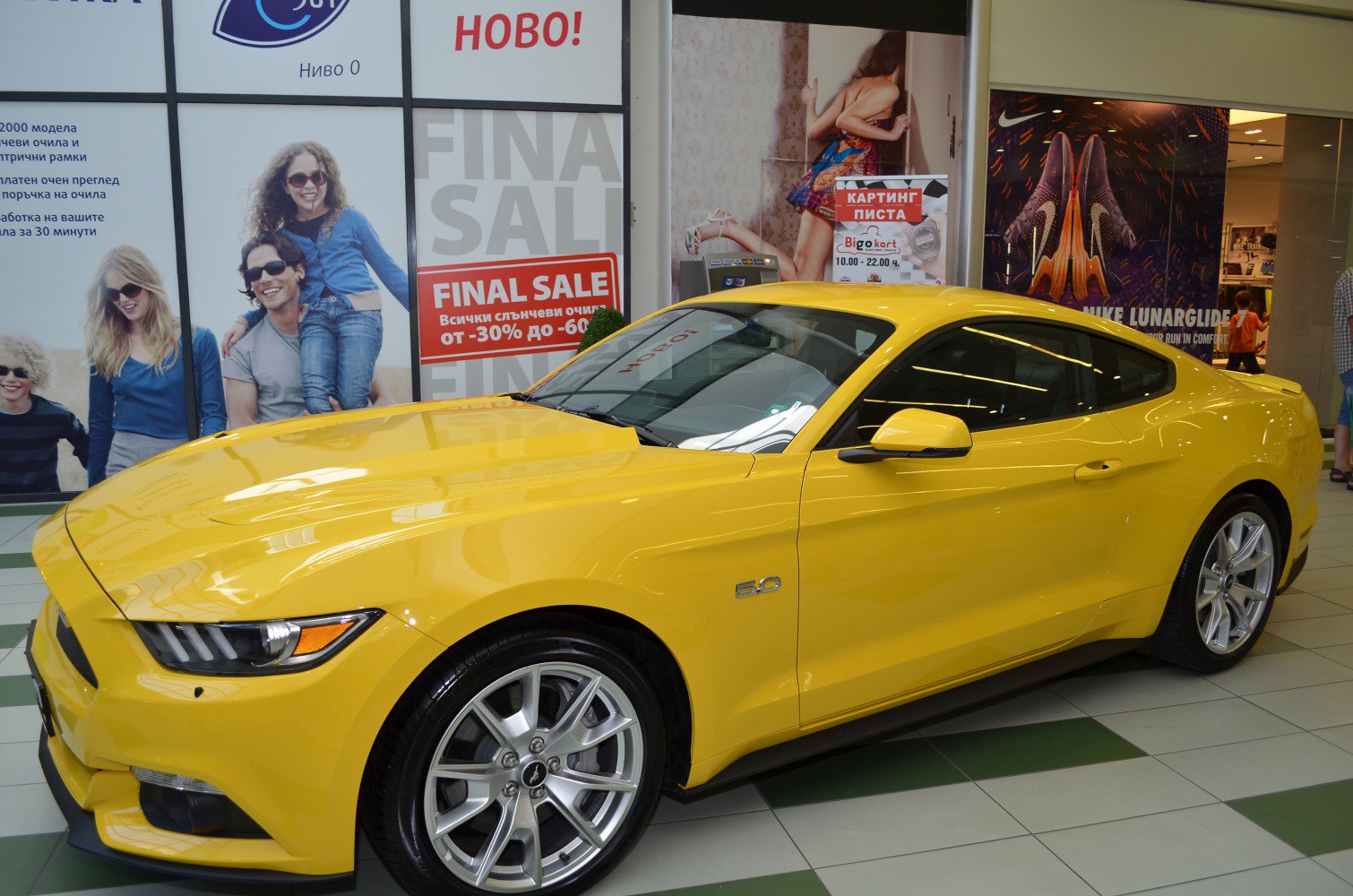 Yellow muscle car with 5.0 badge and alloy wheels