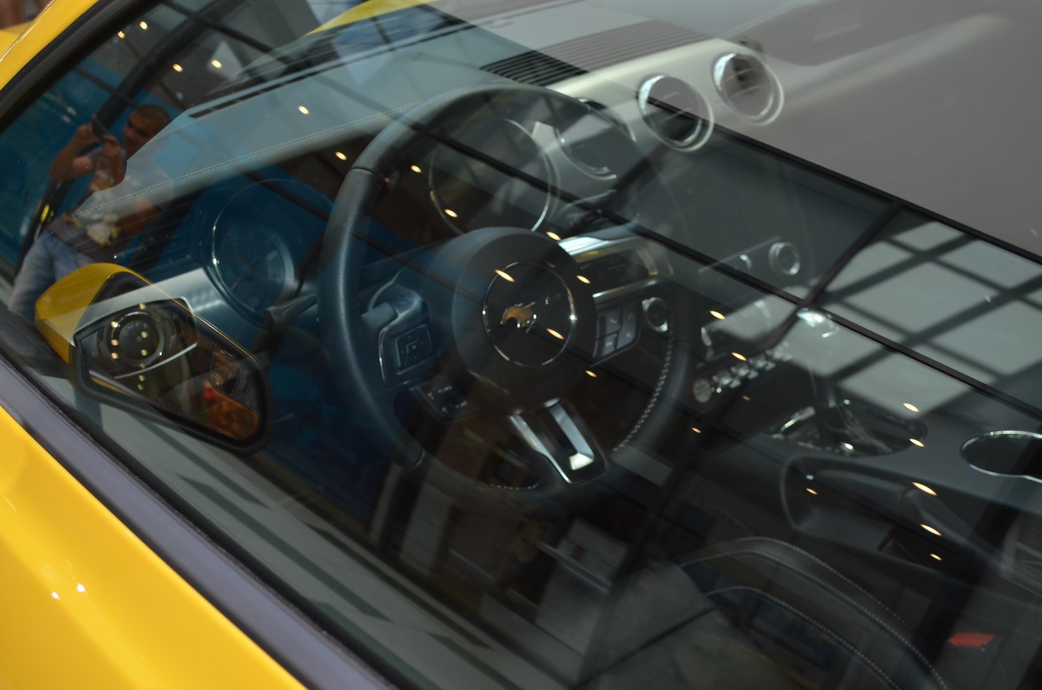 Interior view with steering wheel, air vents, and dashboard controls