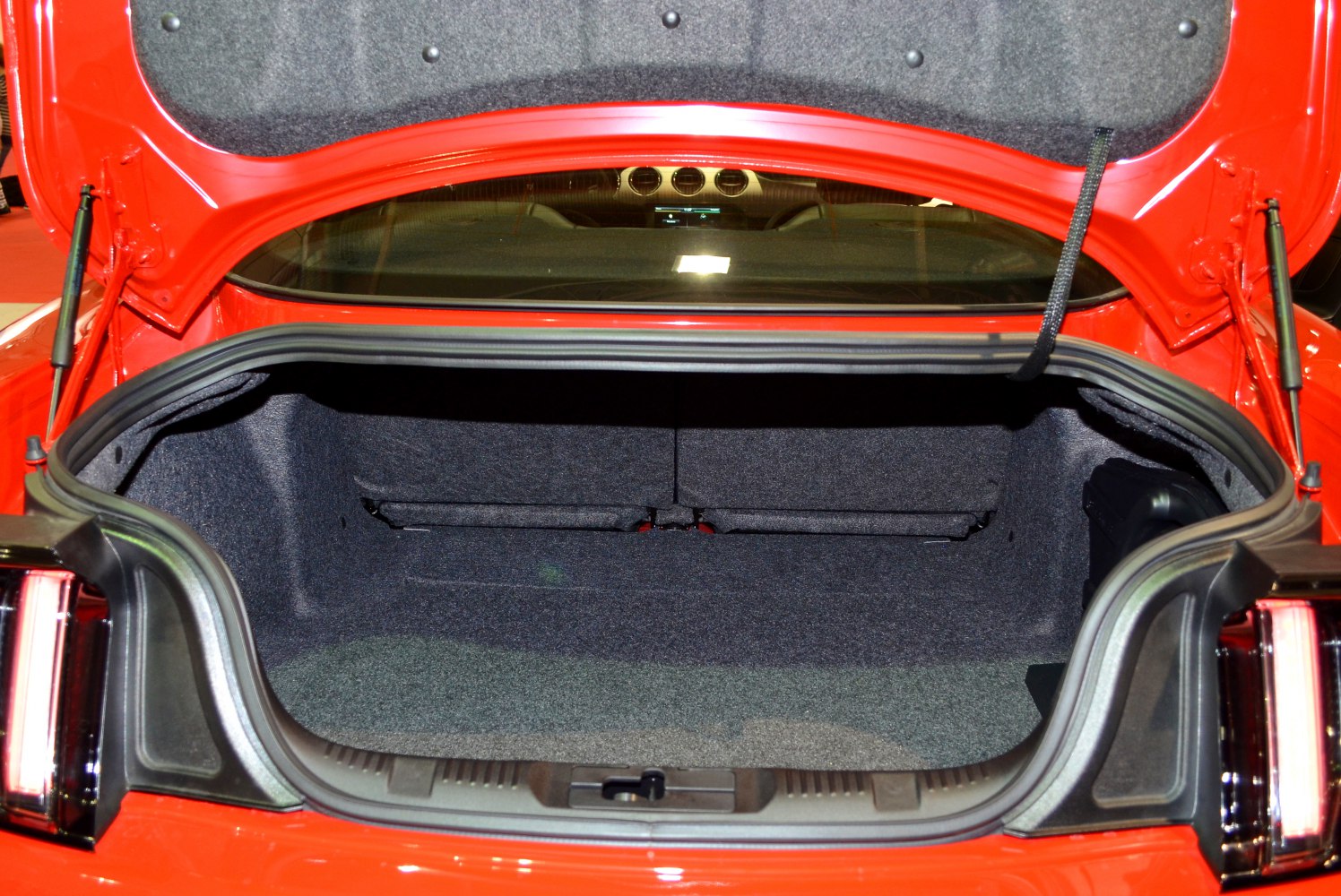 Spacious carpeted trunk interior with rear seat back visible