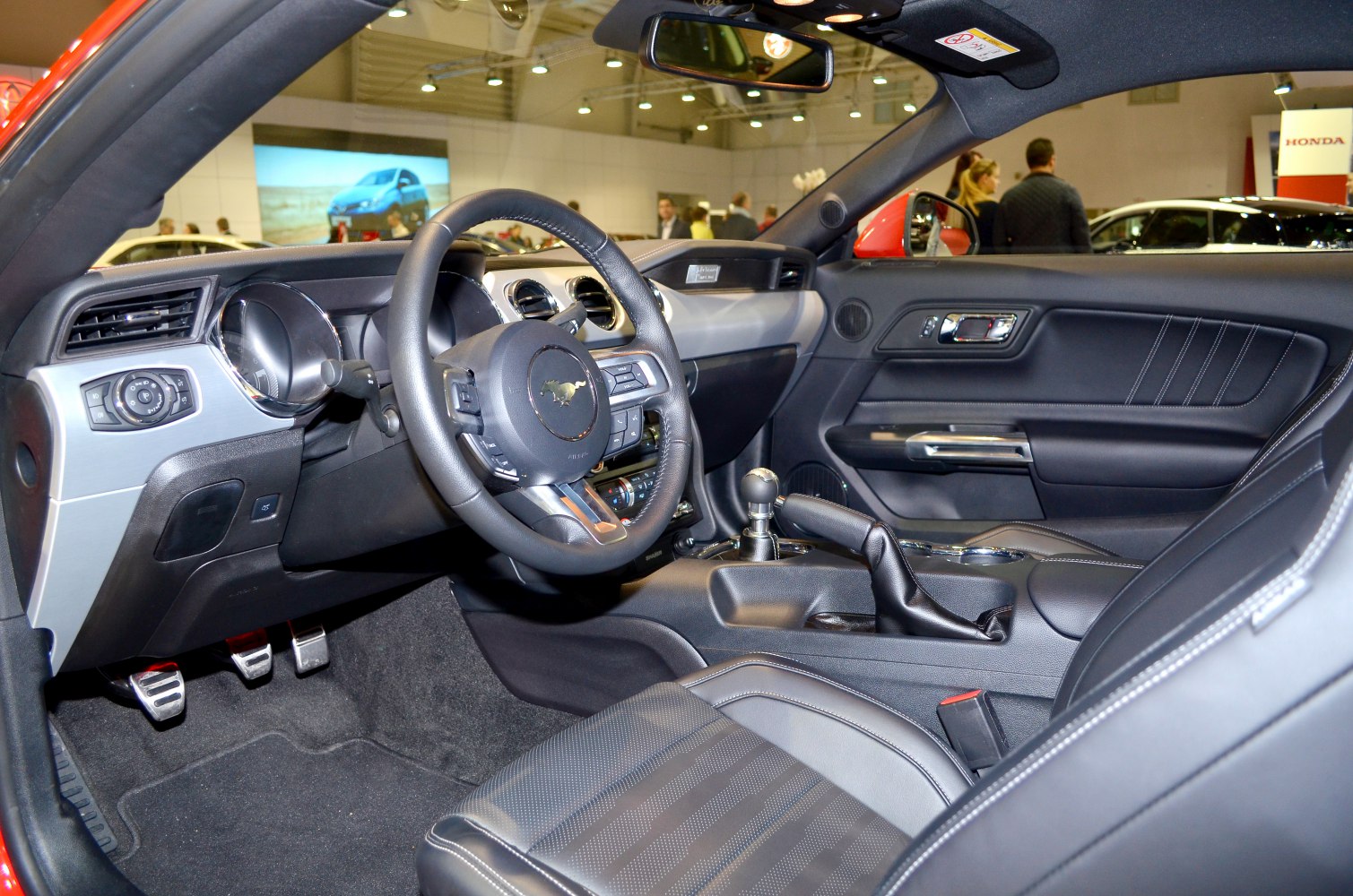 Car interior with steering wheel, dashboard, manual gearshift