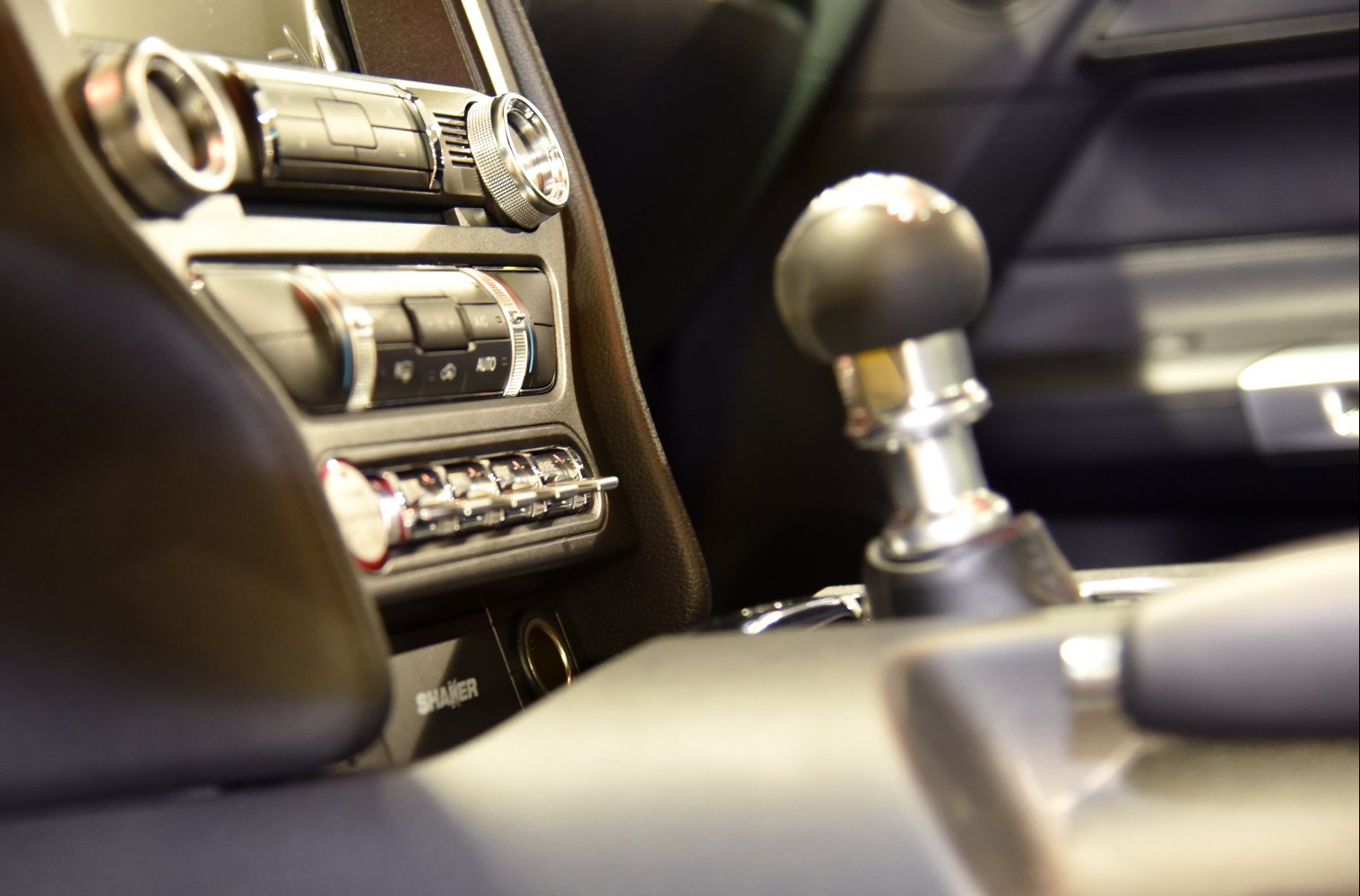 Manual gear shift and climate control panel in car interior