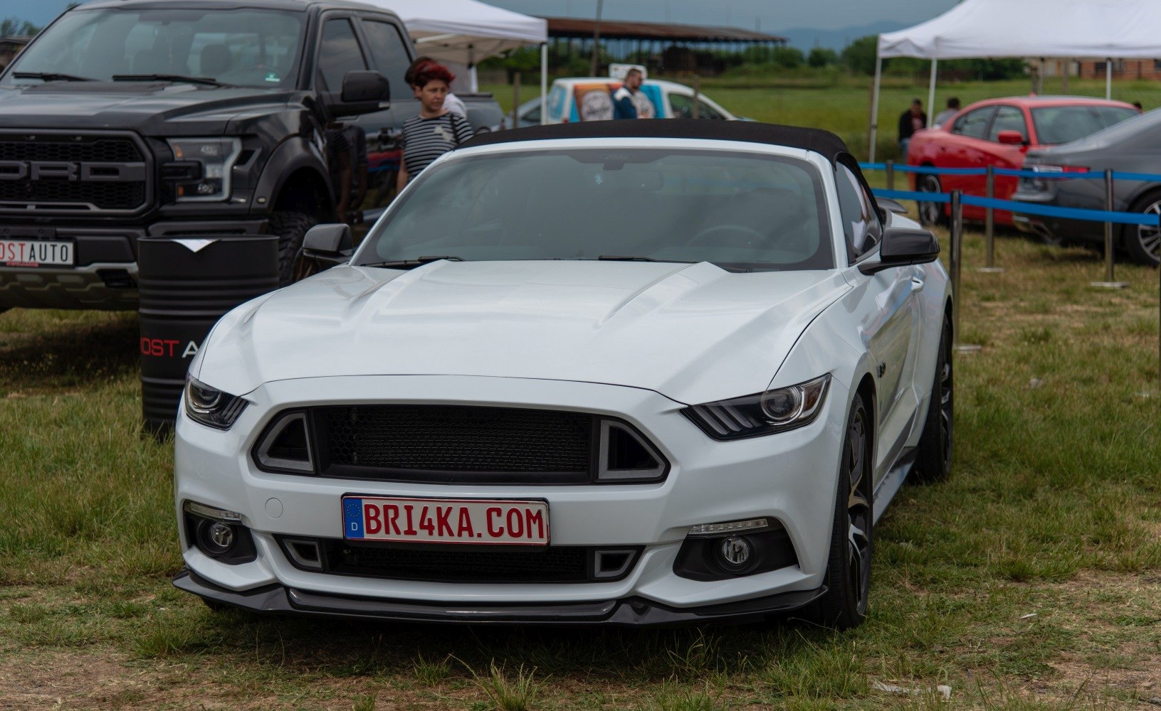 Aggressive headlights and large black grille front view