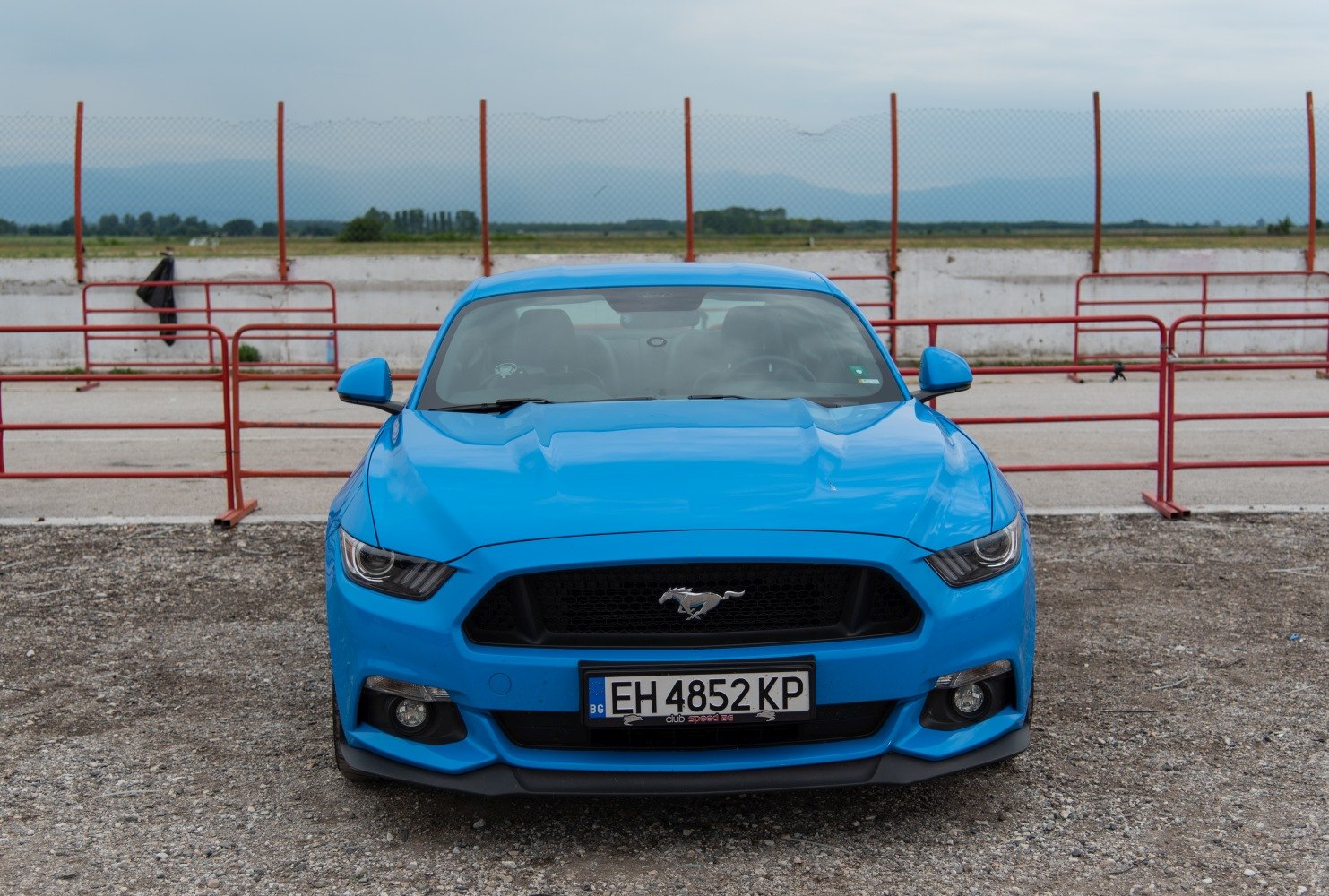 Aggressive front fascia with bold grille and muscular hood.
