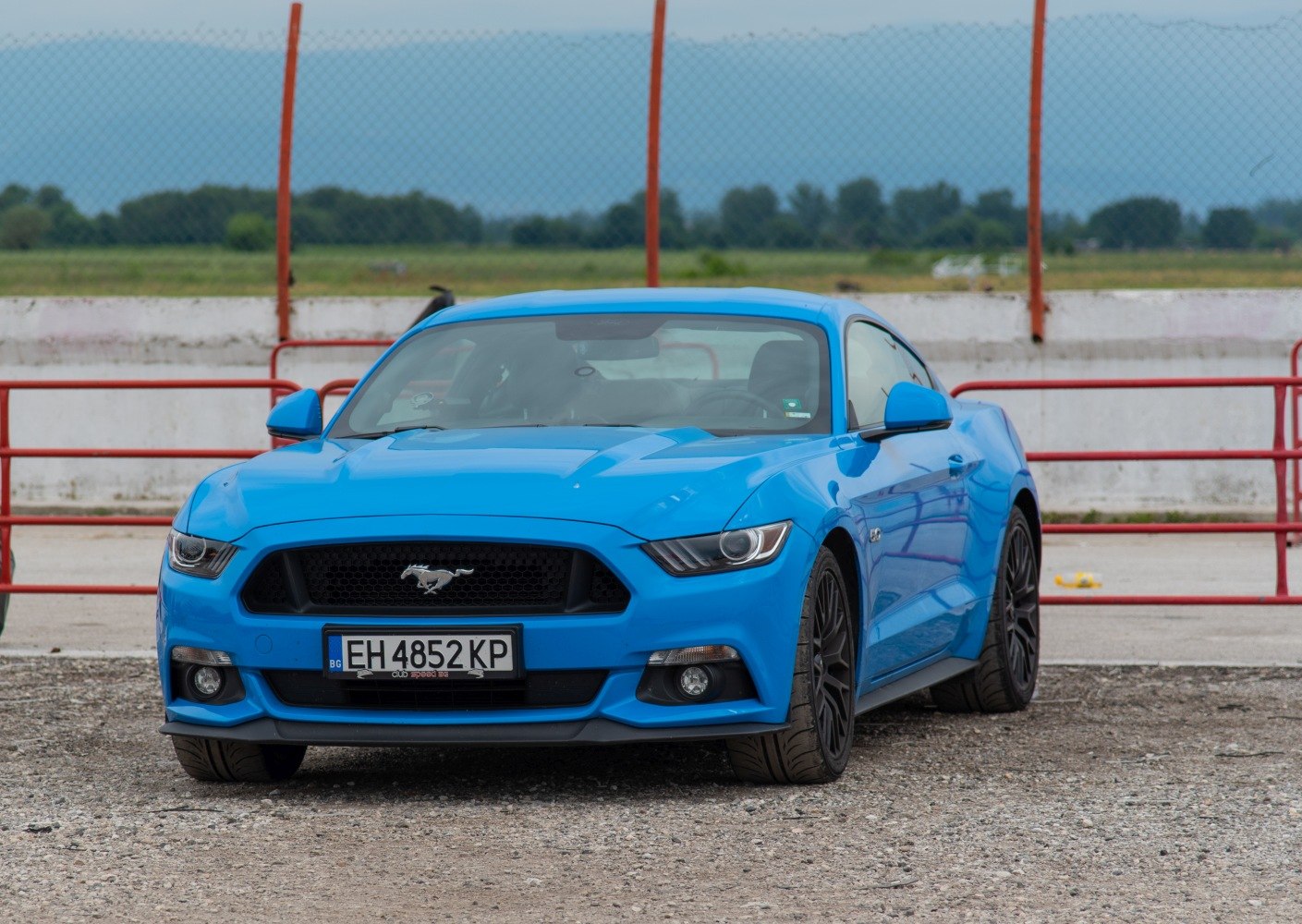 Aggressive front grille and headlights with muscular body design.