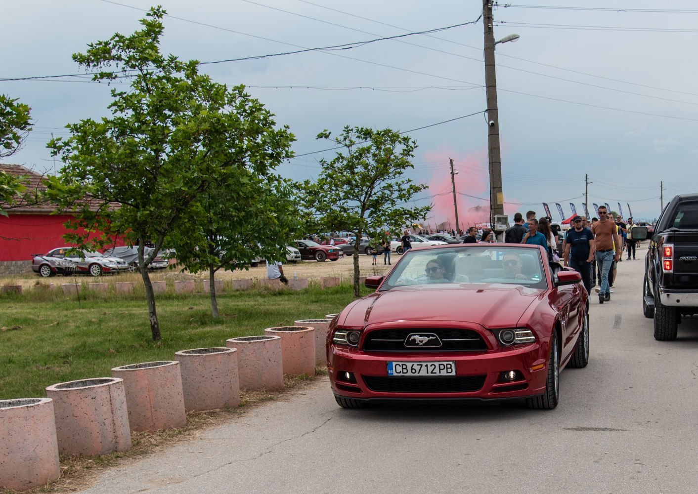 Front view of red convertible with distinctive grille and details