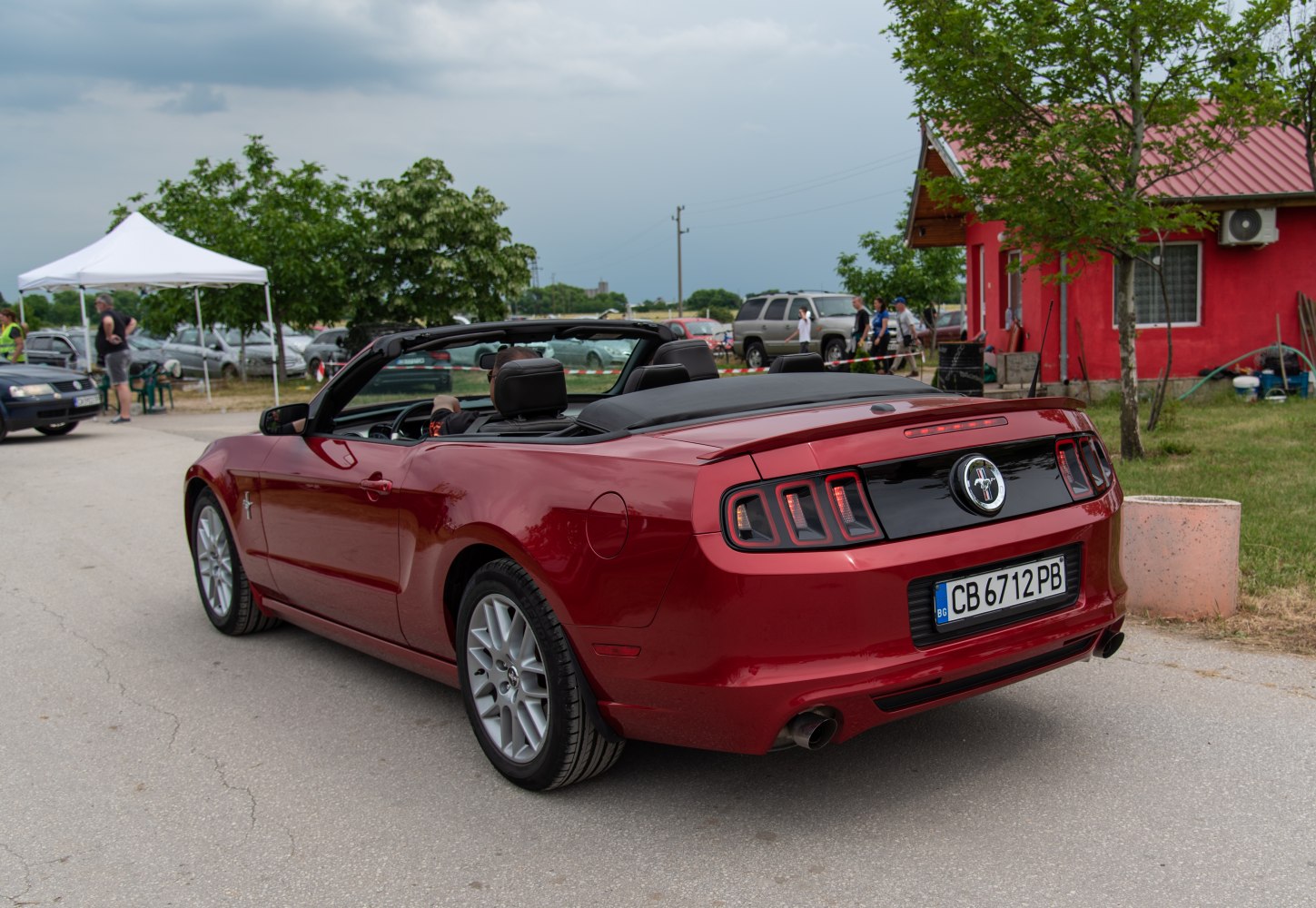 Rear view of red convertible with retractable roof and distinct taillights