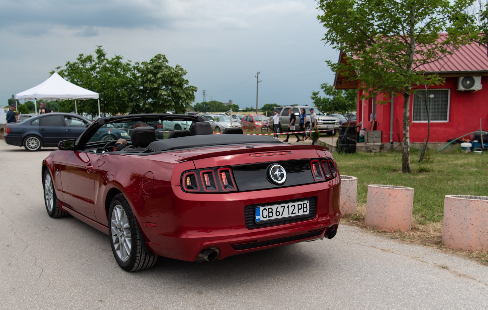 Rear view of a convertible showing triple-segment taillights and dual exhaust pipes