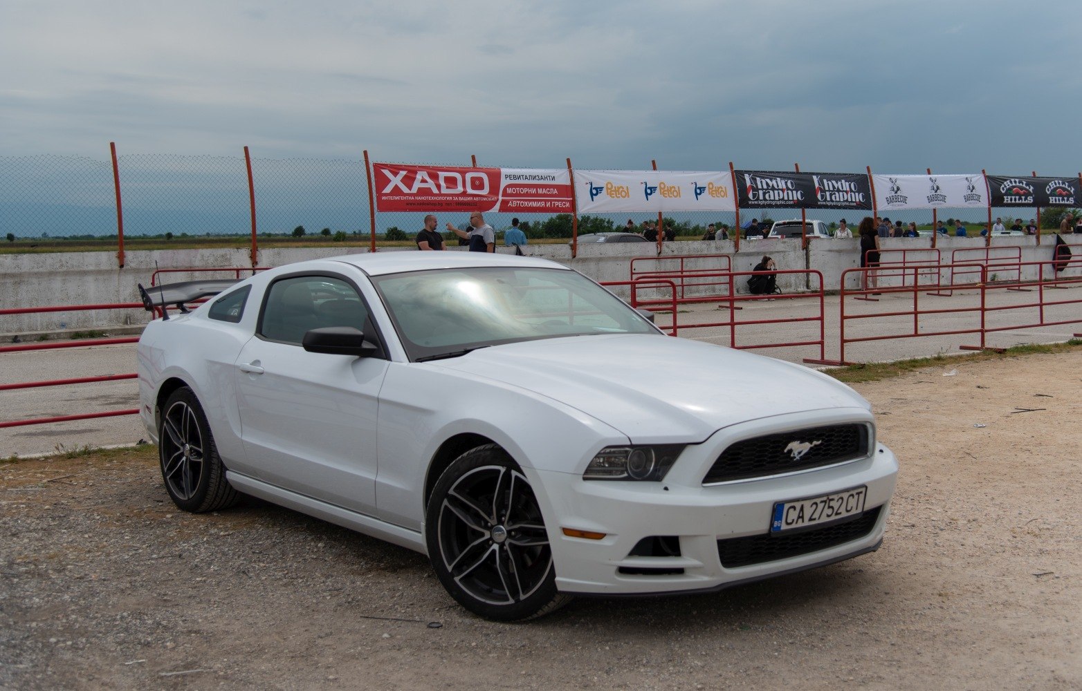 Aggressive front grille and large rear wing spoiler on a sporty coupe