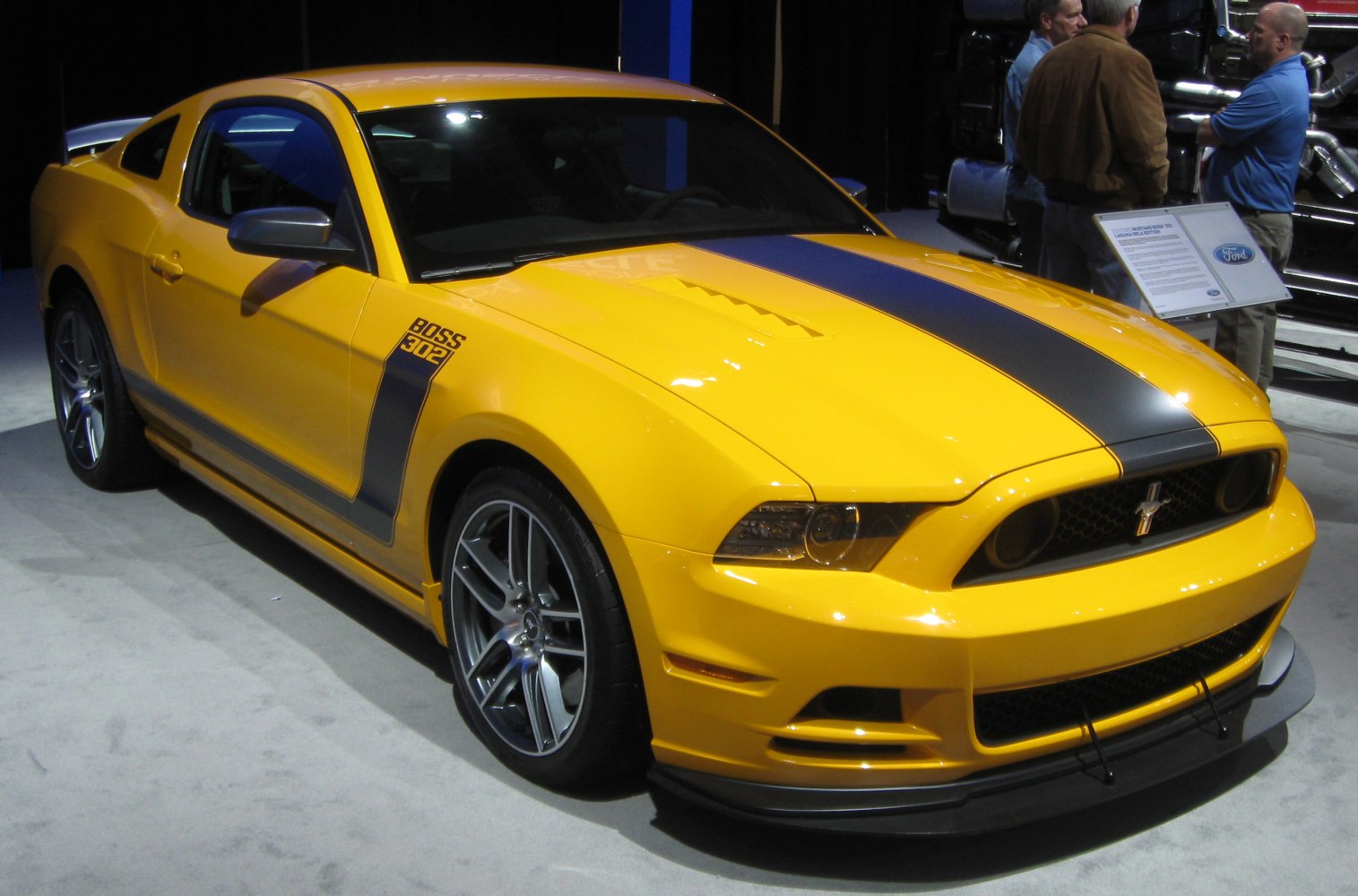 Yellow muscle coupe with black racing stripe and sporty alloy wheels