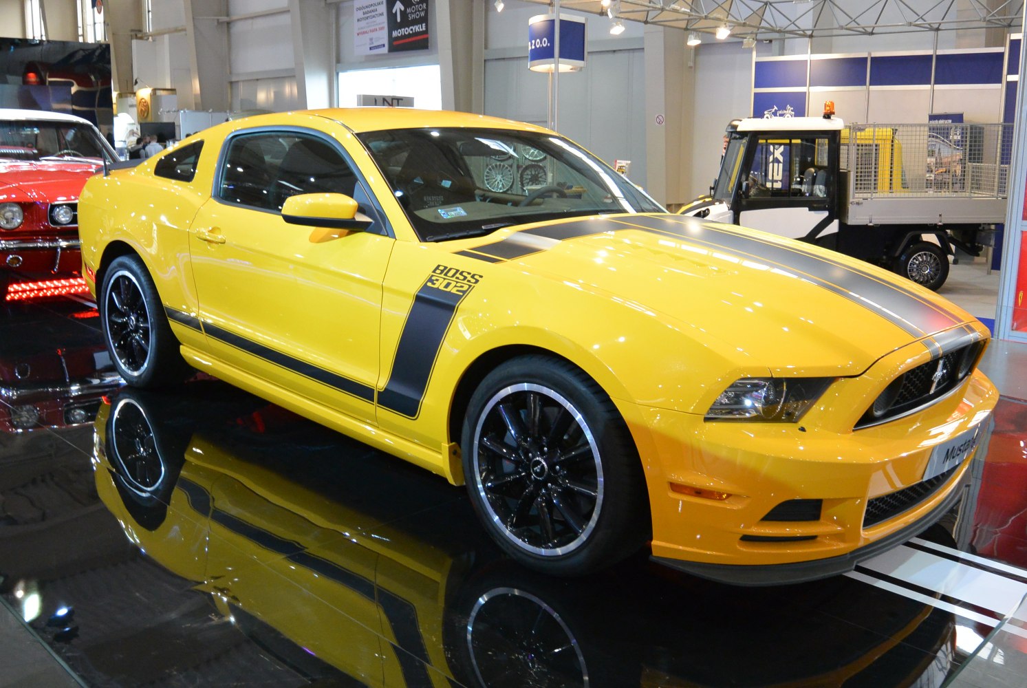 Yellow muscle coupe with black racing stripes and Boss 302 badge