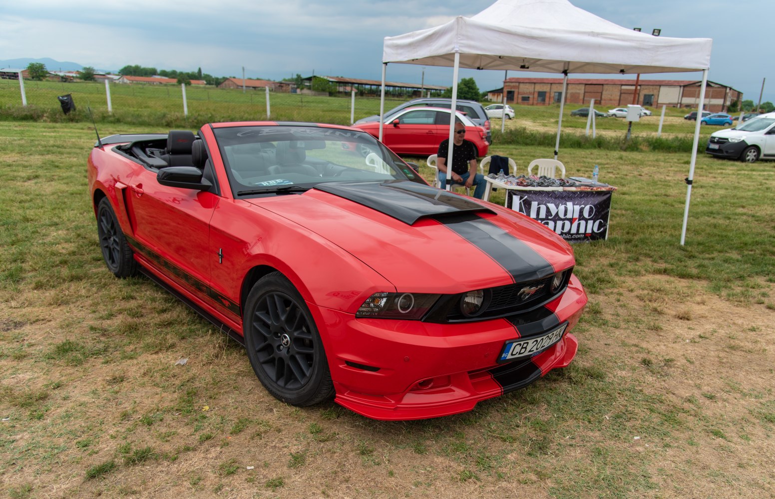 Convertible with black racing stripes and hood scoop
