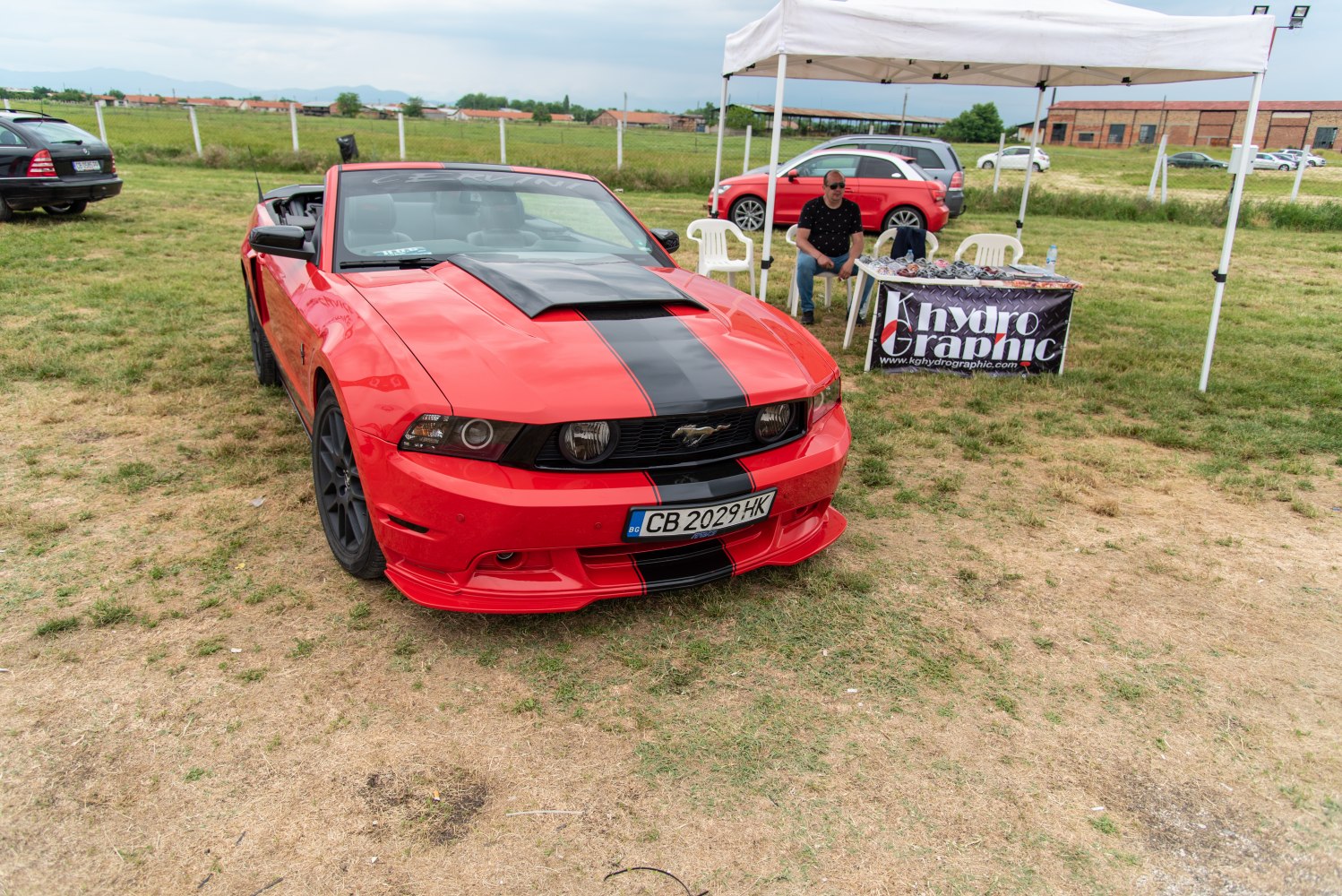 Convertible with black racing stripe and aggressive front grille