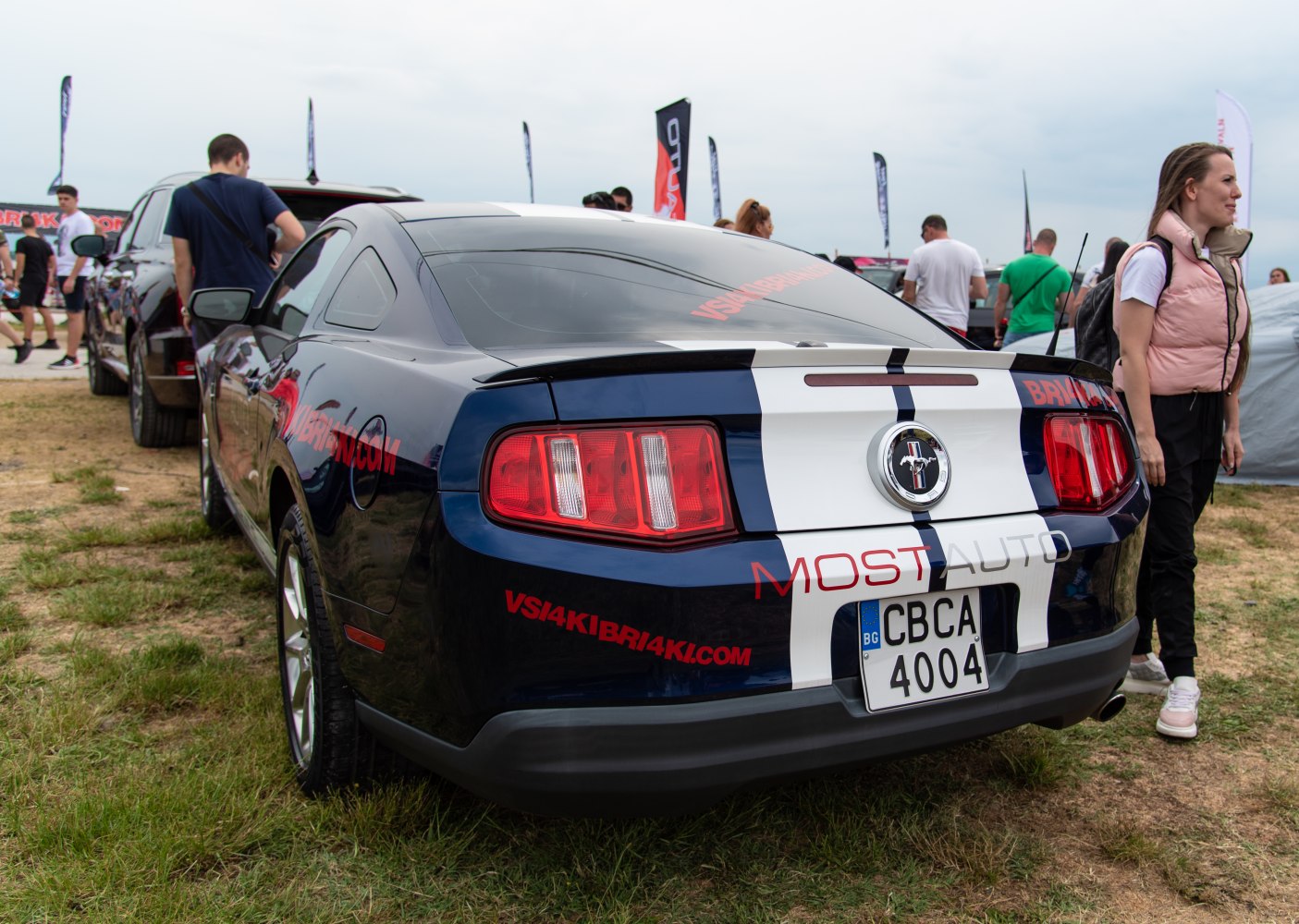Rear of a Mustang with racing stripes and taillights