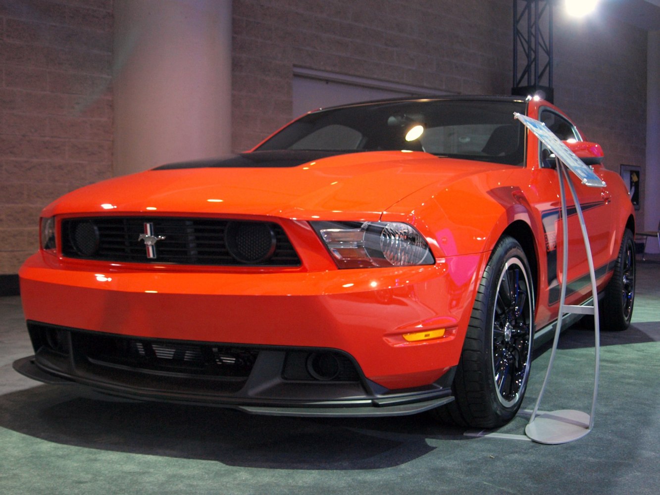 Aggressive front grille and black multi-spoke alloy wheels on red sports car