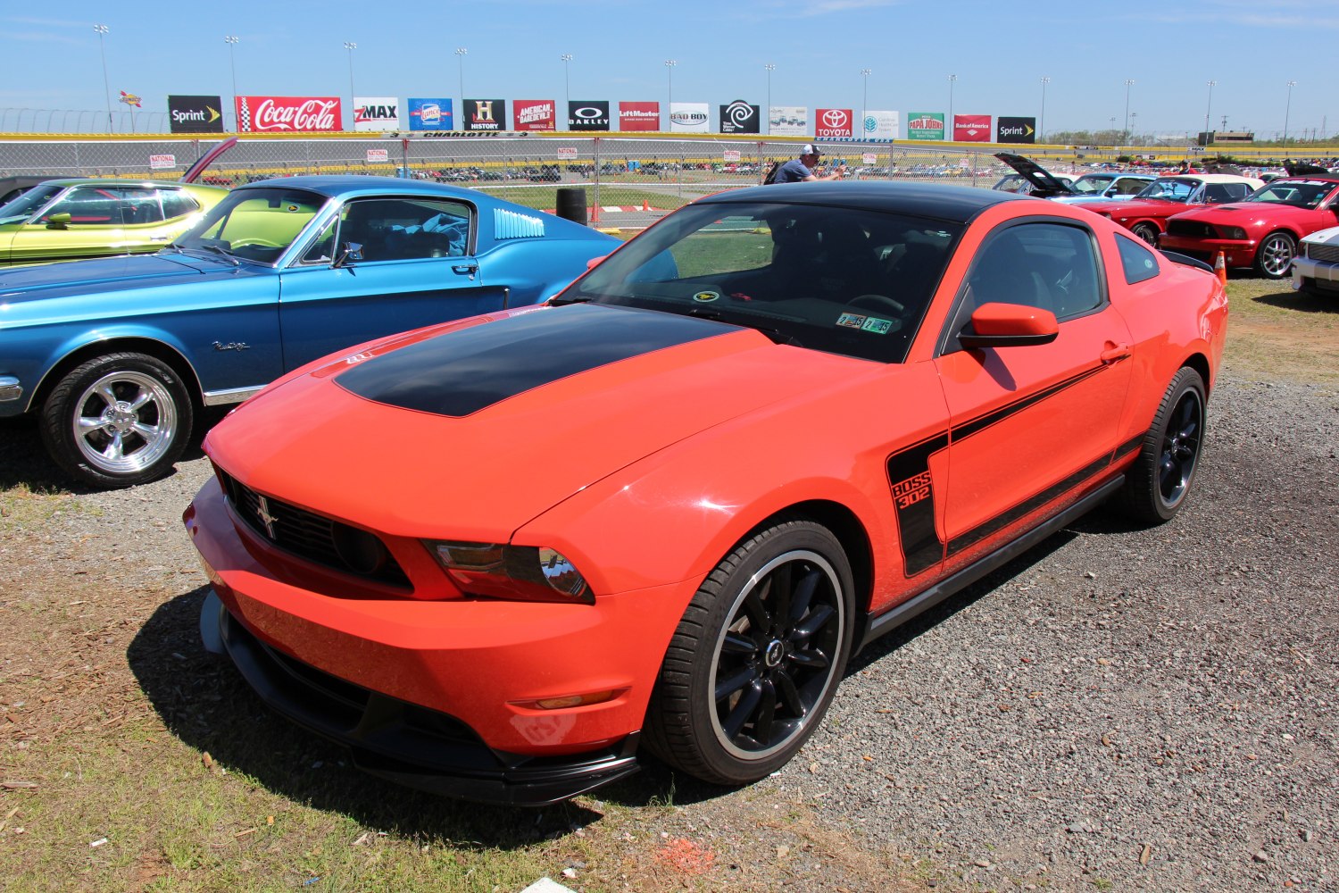 Orange Boss 302 Mustang with black hood and wheels