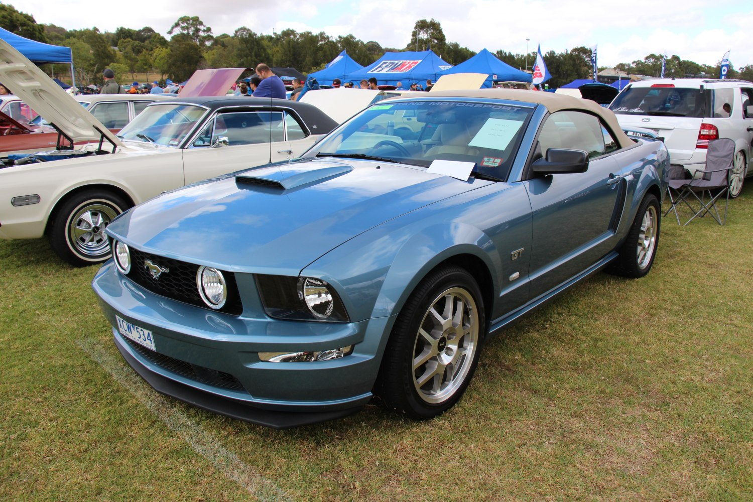 Blue convertible with hood scoop and GT badge