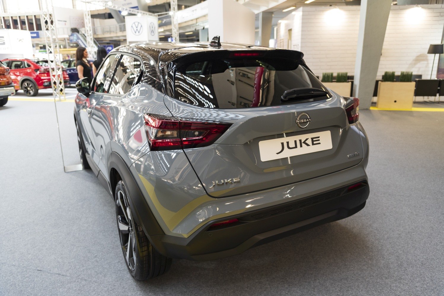 Rear view with modern taillights and hybrid badge on a gray compact crossover vehicle.