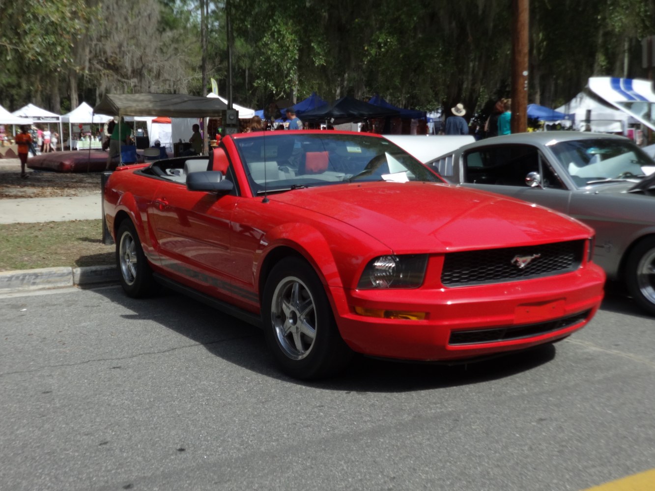 Red convertible with lowered roof and sporty front-side design