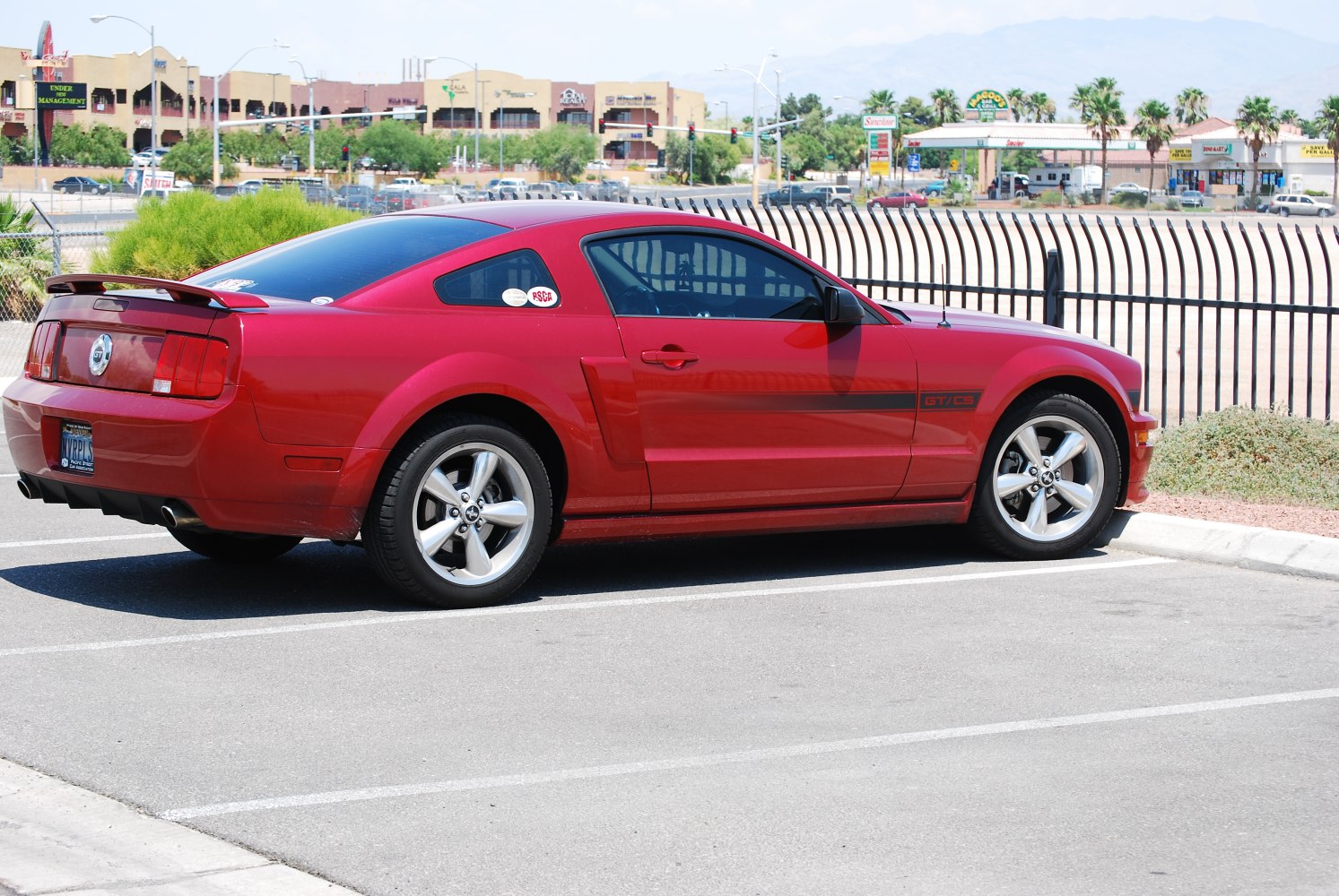 Red sports coupe with side stripes and alloy wheels