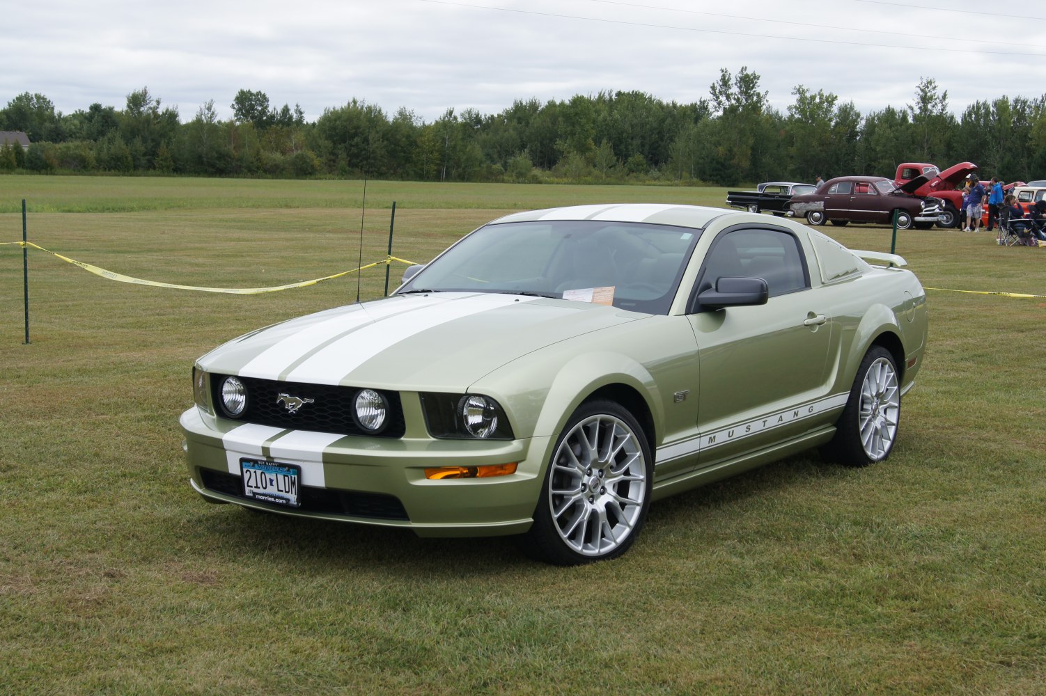 Front view of a muscle coupe with racing stripes and alloy wheels