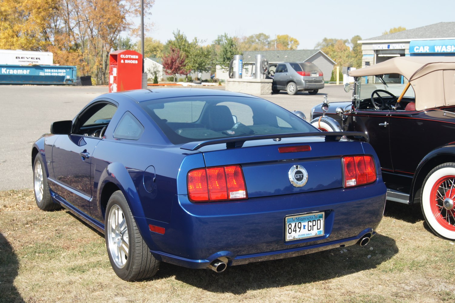 Blue GT coupe rear view with spoiler and dual exhaust