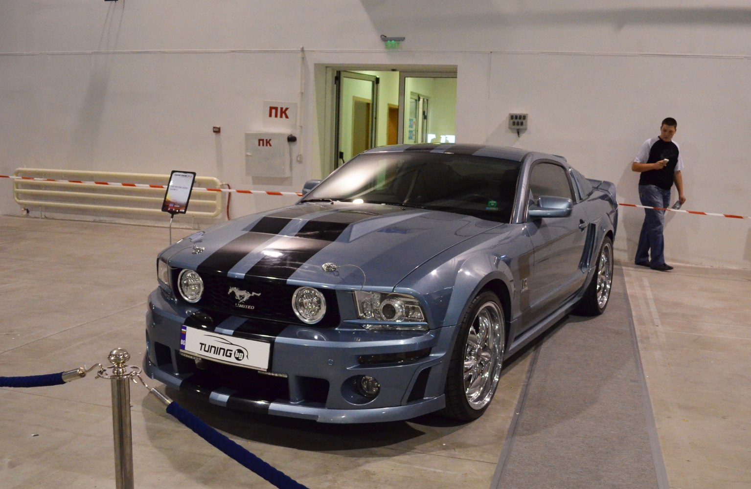 Customized muscle car with racing stripes and sporty front grille