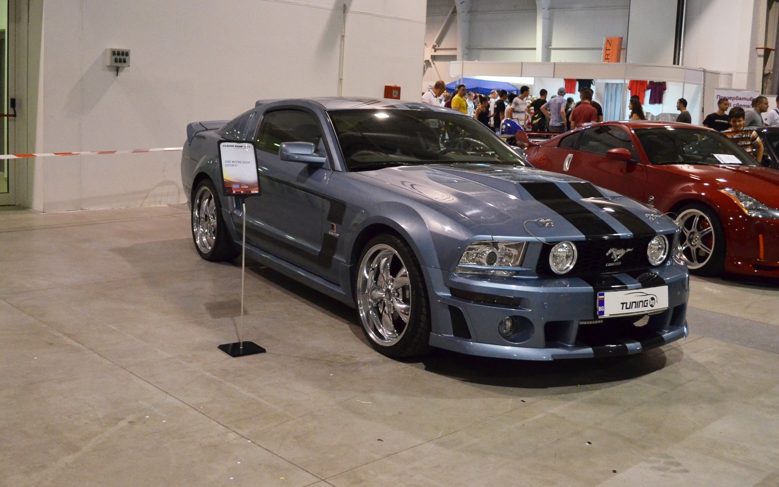 Customized Mustang V with racing stripes and chrome wheels