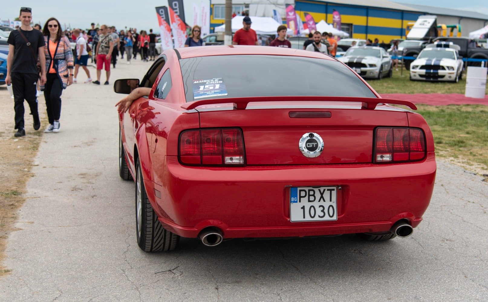 Red muscle coupe rear with spoiler and dual exhaust