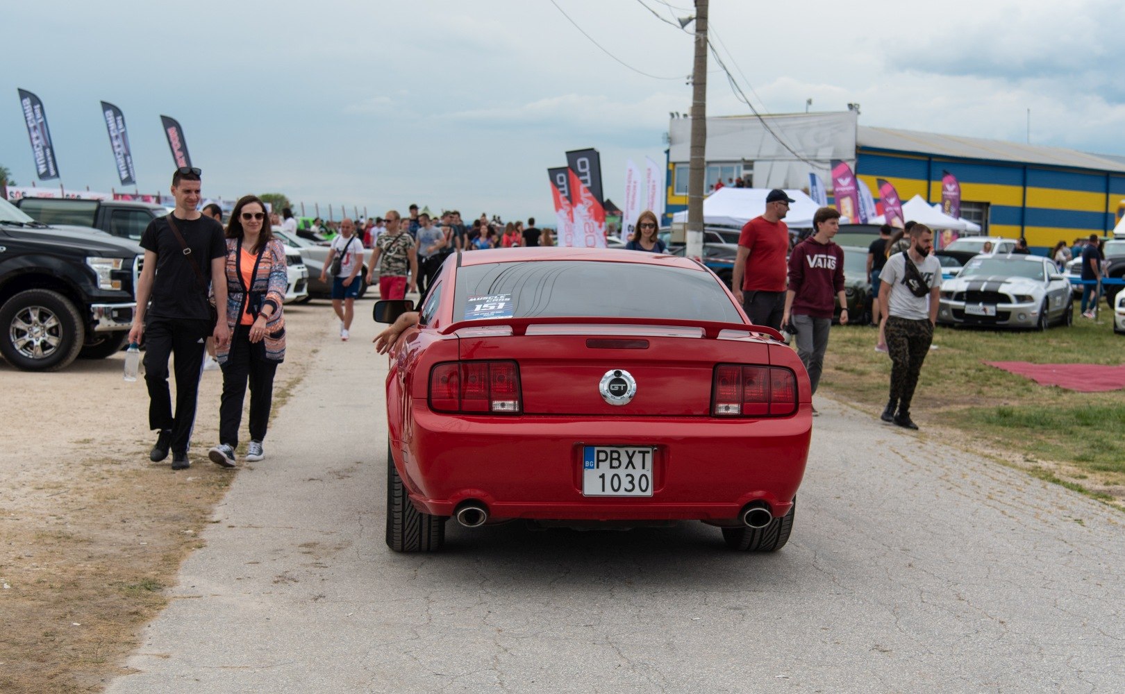 Rear view of red Mustang V GT with dual exhaust and spoiler