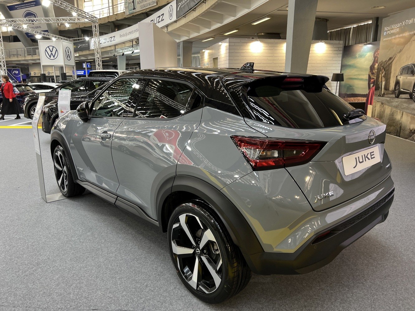Rear side with taillights, two-tone roof, and alloy wheels.