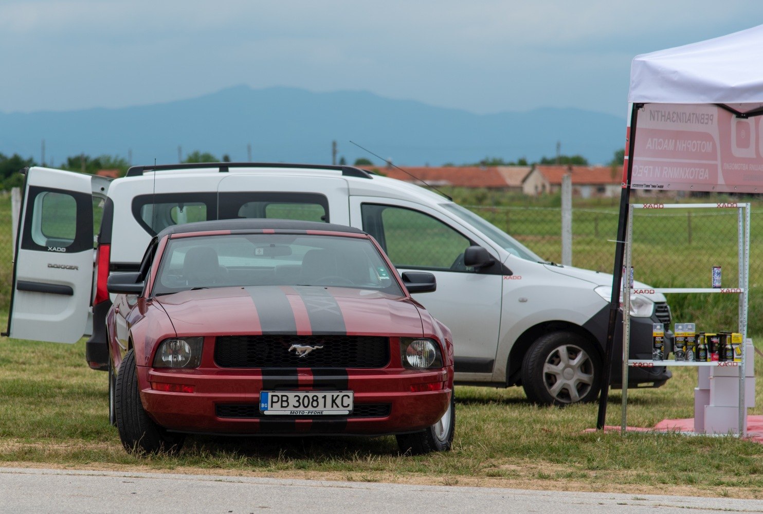 Front view of muscle car with racing stripes and pony emblem