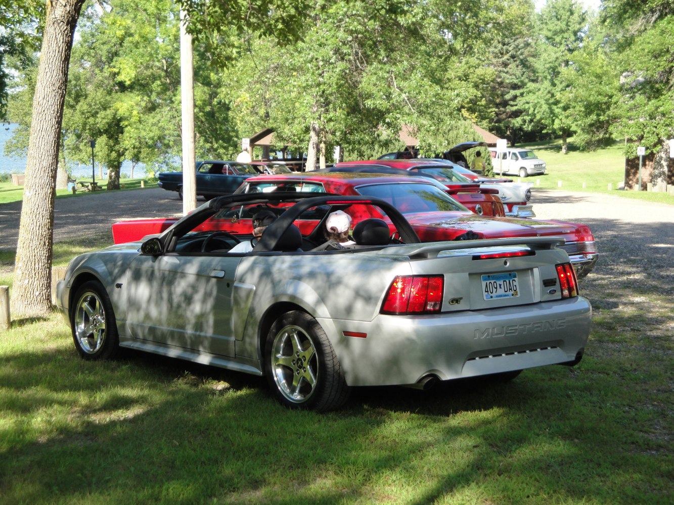 Rear view of a convertible sports car with GT badge and chrome wheels