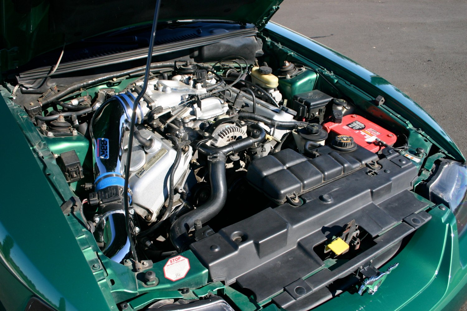 Engine bay with polished performance air intake system.