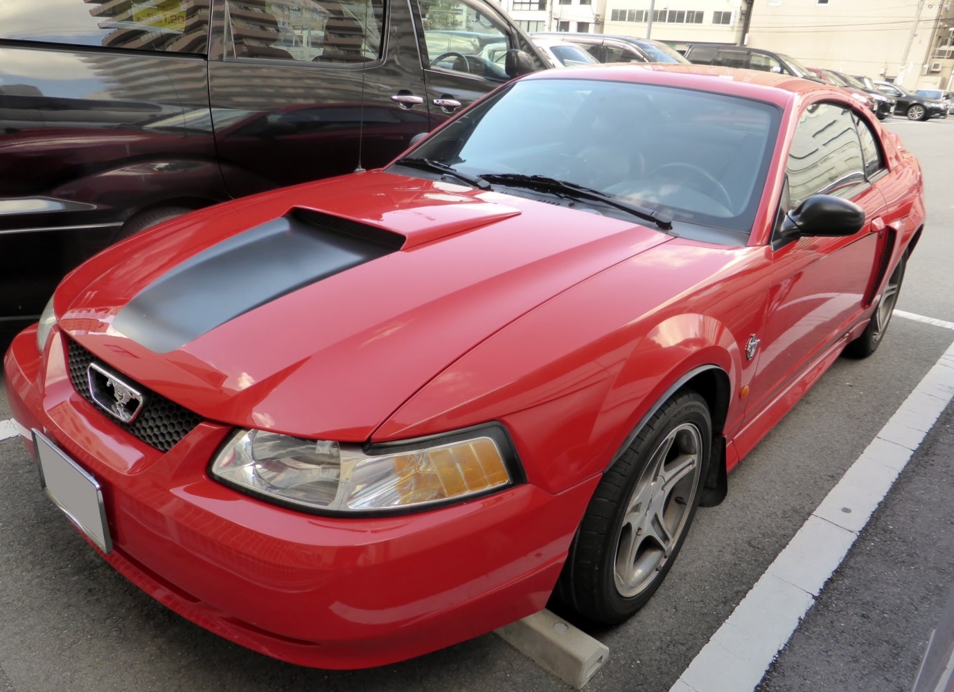 Sporty red coupe with bold hood scoop and aerodynamic design