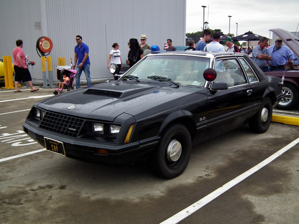 Vintage black 1979 coupe with police lights and 5.0L engine badge