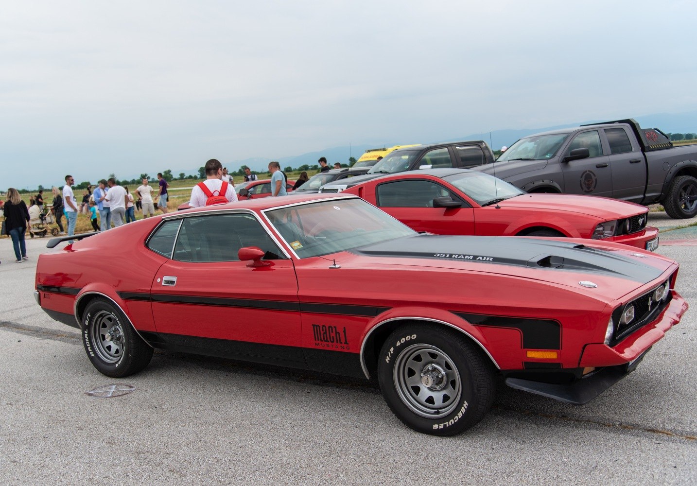 Red 1971 muscle coupe with 351 Ram Air hood and Mach 1 stripes