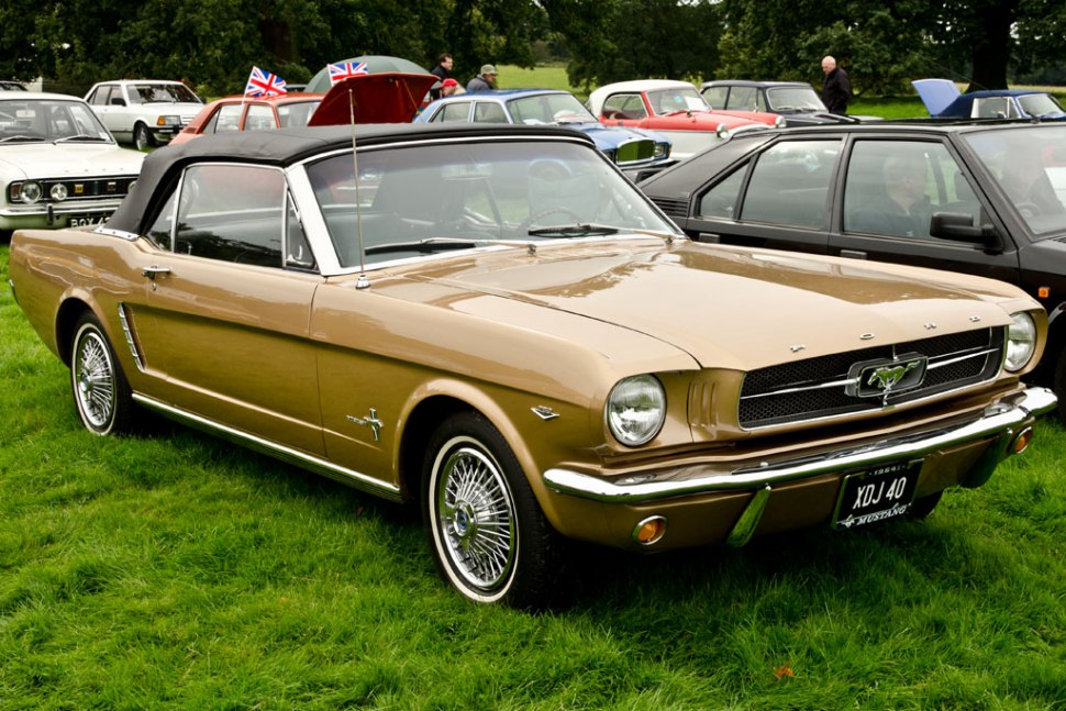Vintage 1960s convertible with soft top and wire-spoke chrome wheels