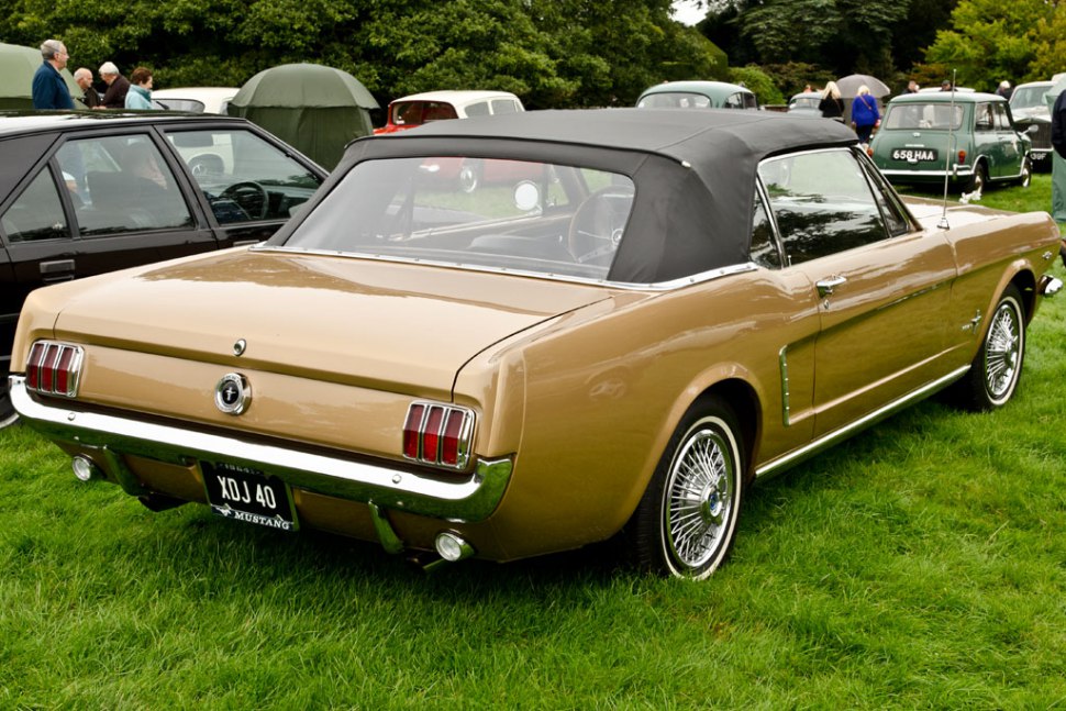 Rear view of a classic convertible with wire wheels.