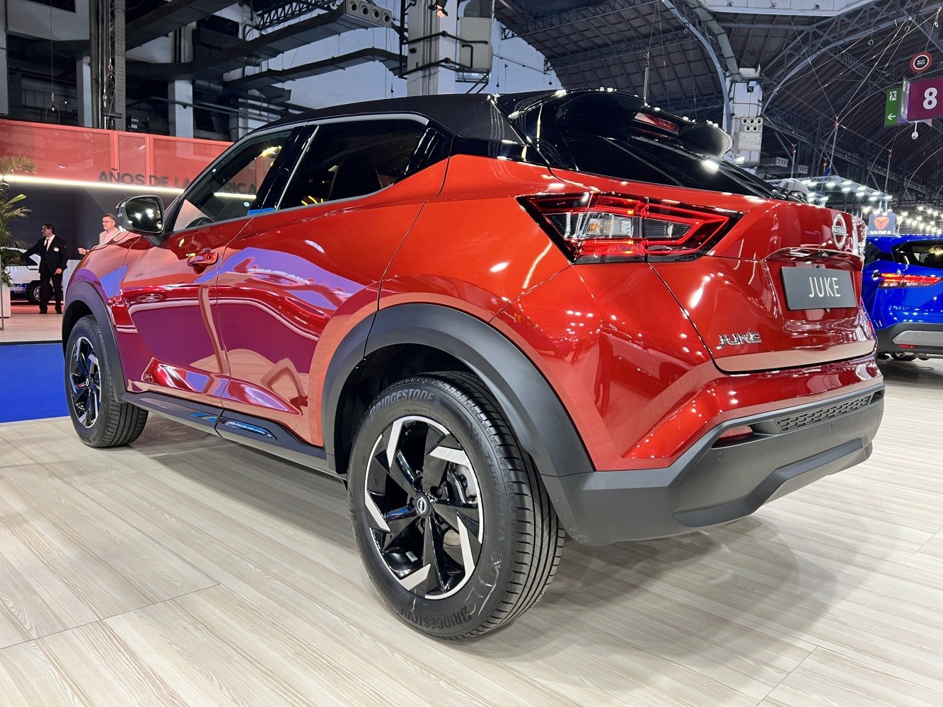 Rear three-quarter view of red compact SUV with angular taillights and black roof