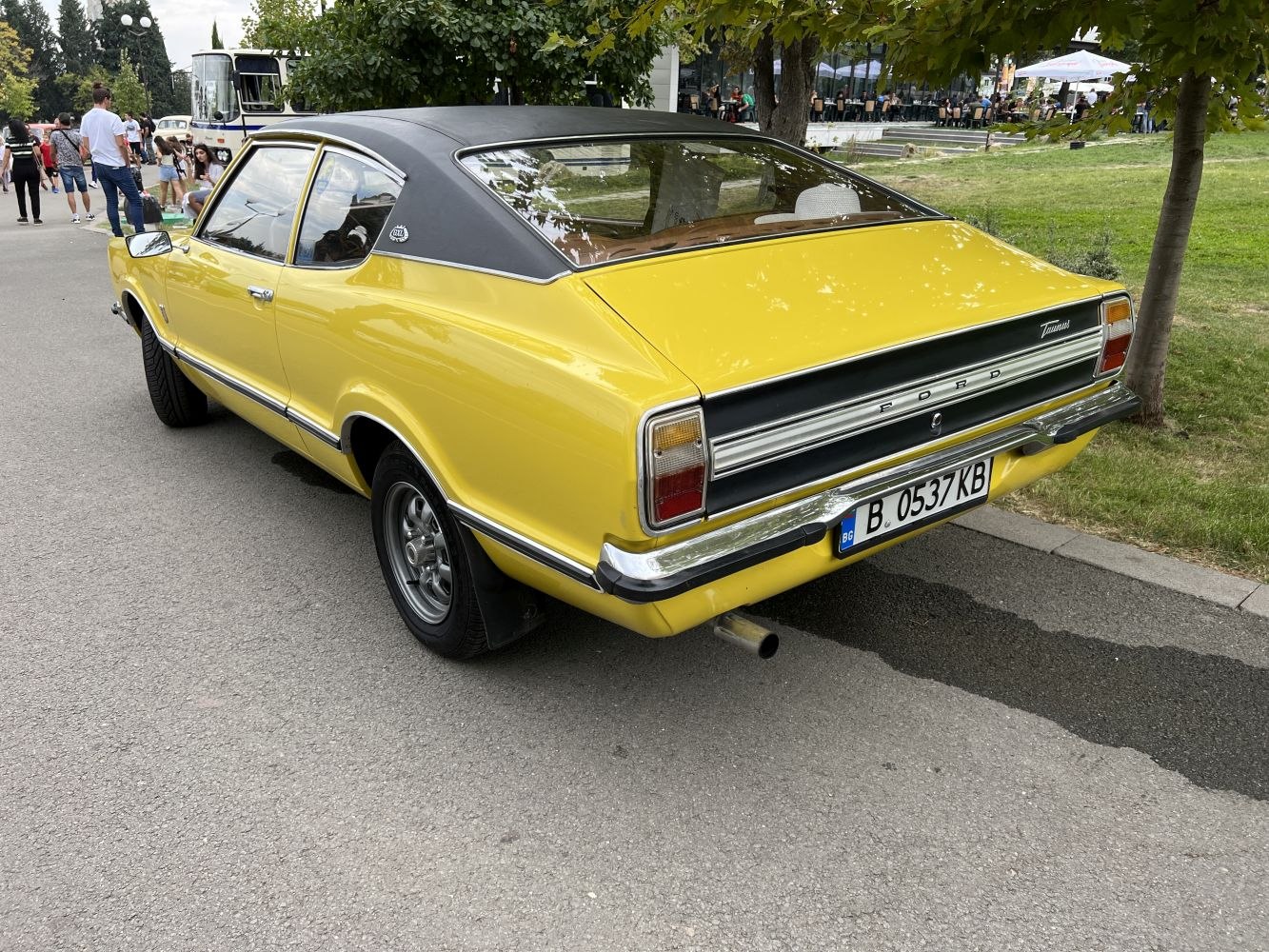 Vintage yellow coupe with distinctive rear design and vinyl roof