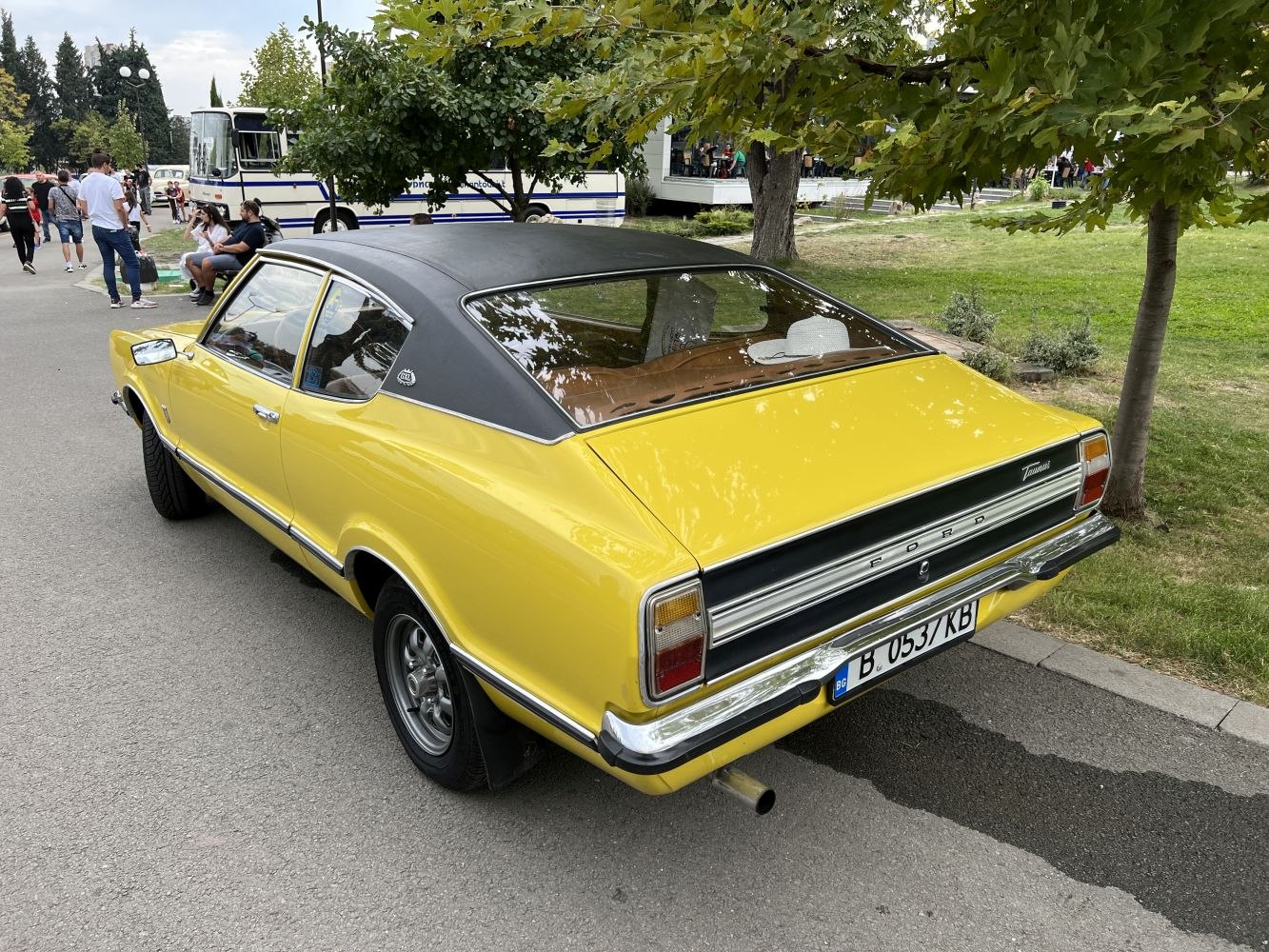 Yellow coupe with vinyl roof and wide rear window